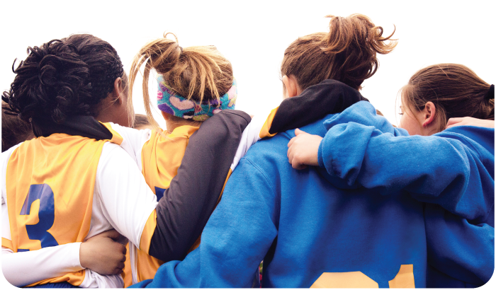 A girls' sports team celebrating together