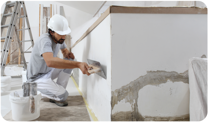 A man applying plaster